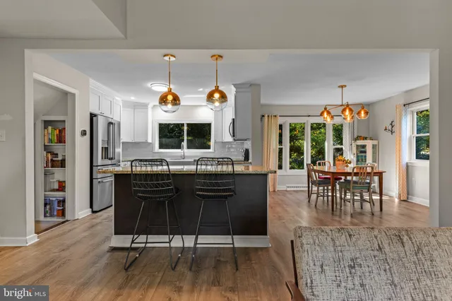 a living room with furniture a dining table and a fireplace