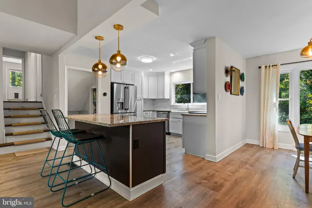 a view of kitchen island with furniture and wooden floor