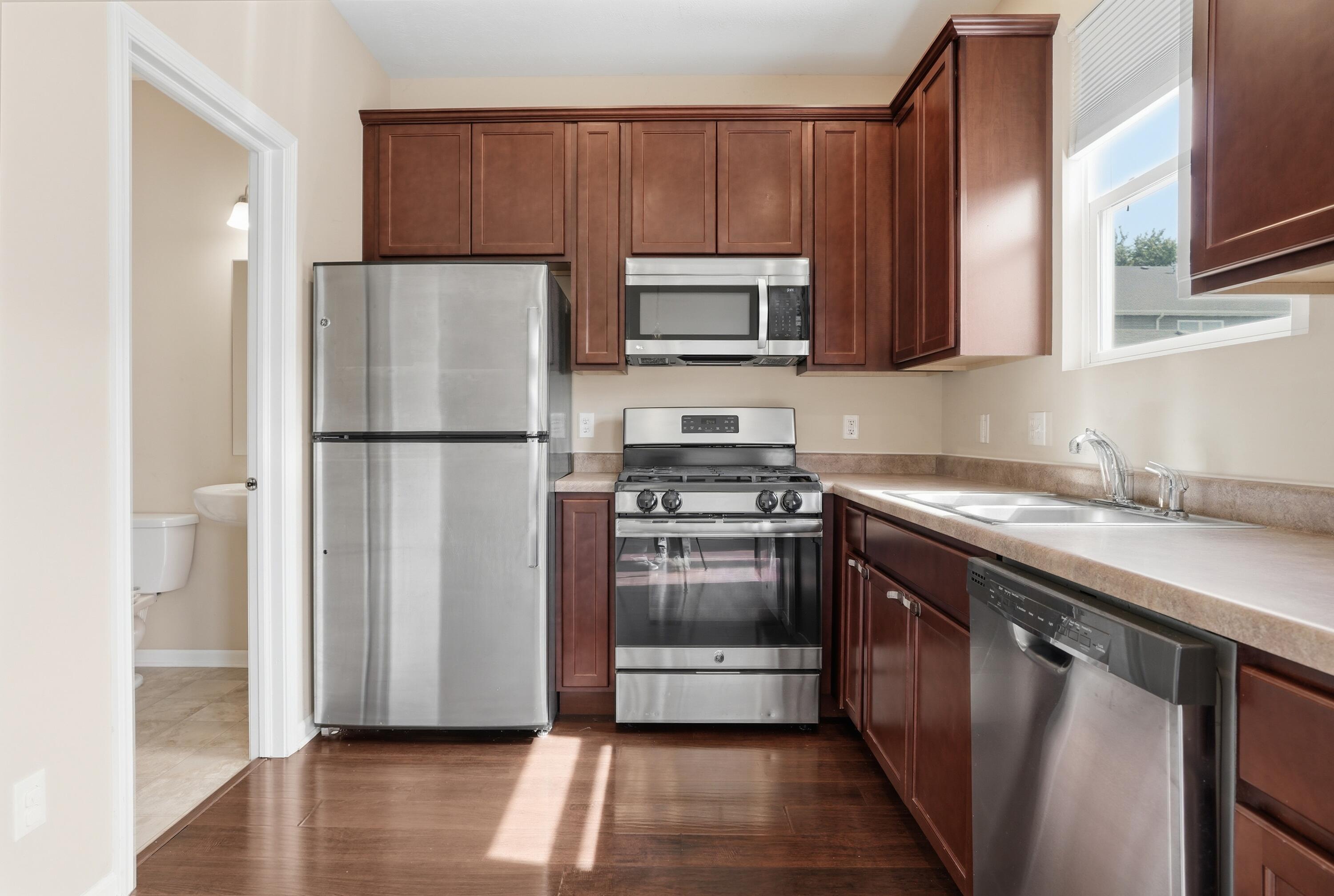 11351 Rhode Island Street Crown Point, IN 46307 - Photo 4 of 18 a kitchen with a refrigerator sink and microwave