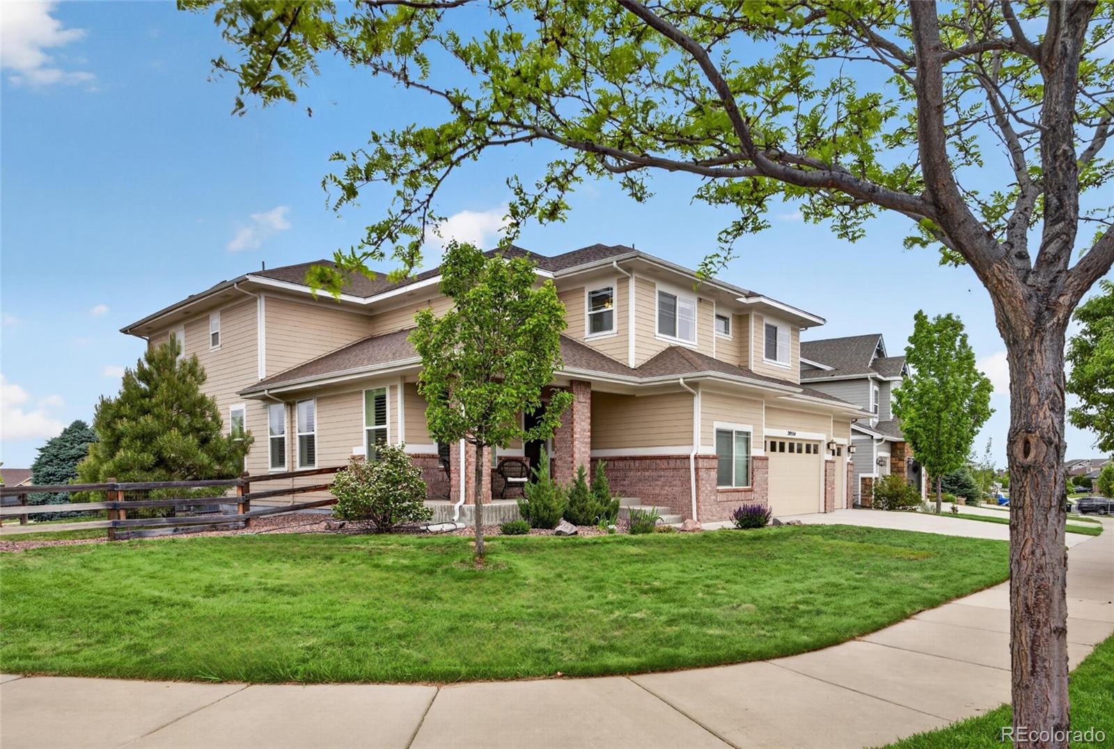 20554 East Shady Ridge Road Parker, CO 80134 - Photo 2 of 49 front view of a house with a garden