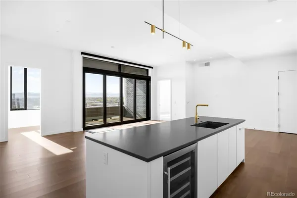 a kitchen with a stove a counter space and wooden floor