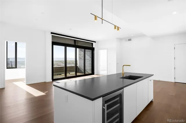 a kitchen with a stove a counter space and wooden floor