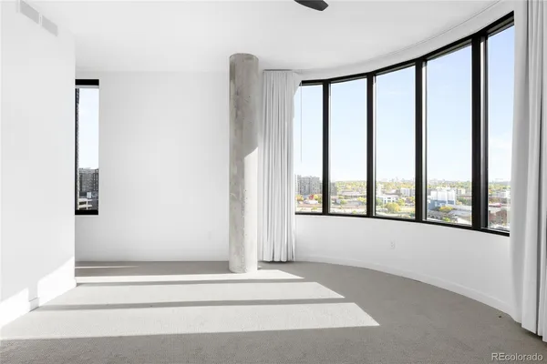 a view of an empty room with windows