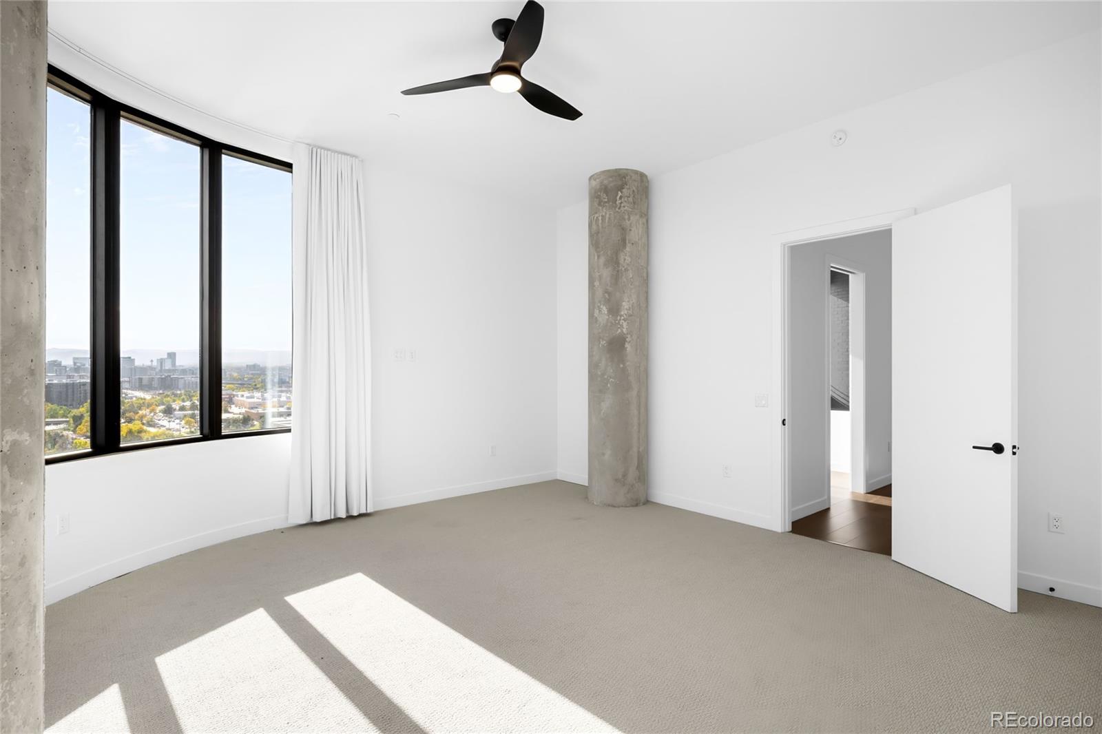 3520 Chestnut Place, Unit PH1207 Denver, CO 80216 - Photo 16 of 37 a view of an empty room with windows