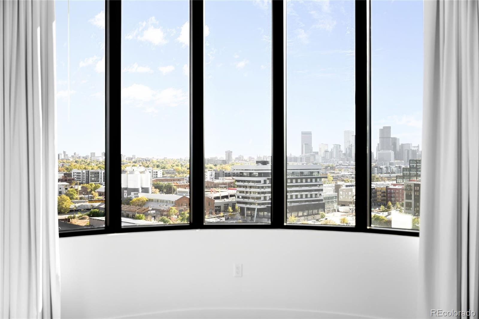 3520 Chestnut Place, Unit PH1207 Denver, CO 80216 - Photo 17 of 37 a view of a city from a window