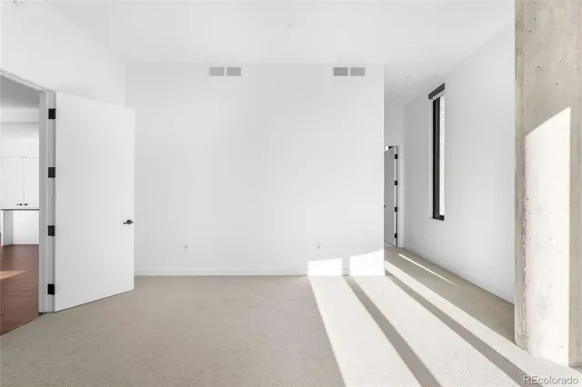 a bathroom with a double vanity sink a toilet a mirror and shower