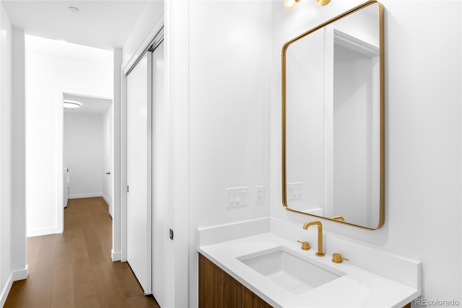 3520 Chestnut Place, Unit PH1207 Denver, CO 80216 - Photo 27 of 37 a bathroom with a sink and a mirror
