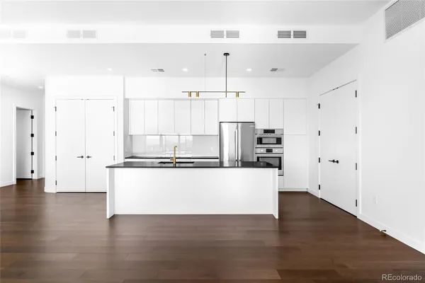 a kitchen with a sink and refrigerator