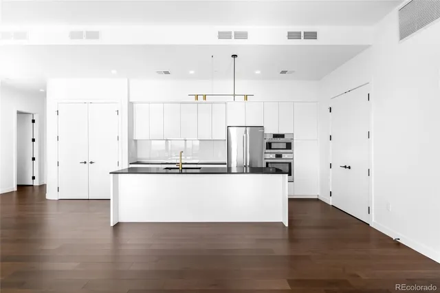 a kitchen with a sink and refrigerator