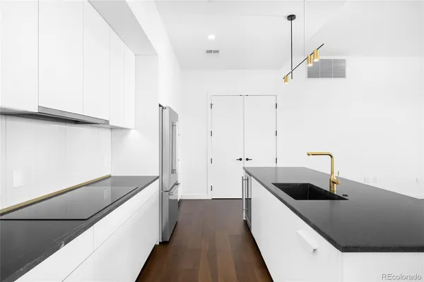 a view of a kitchen with a sink and a large window