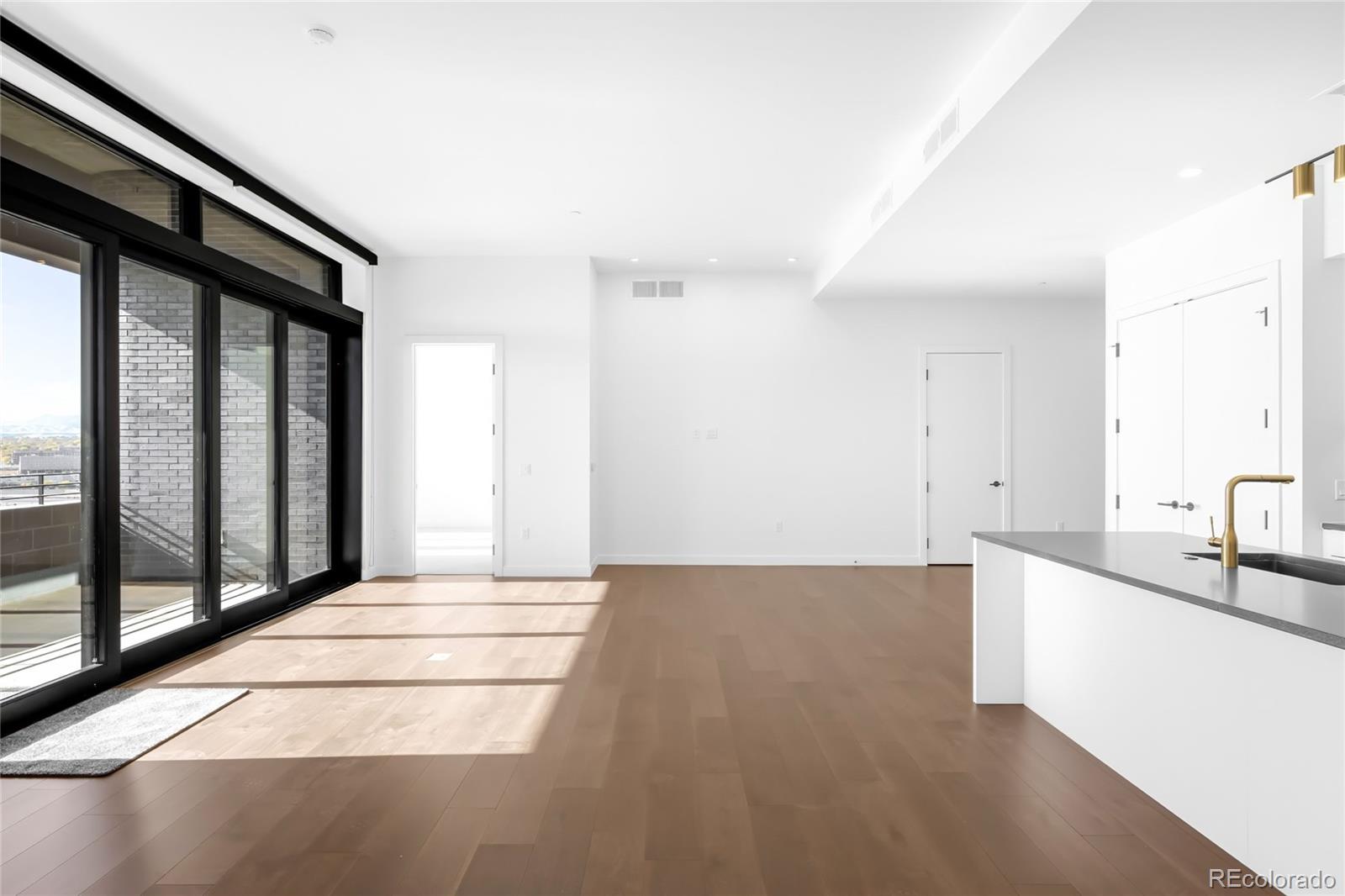 3520 Chestnut Place, Unit PH1207 Denver, CO 80216 - Photo 7 of 37 a view of a kitchen with a sink and a large window