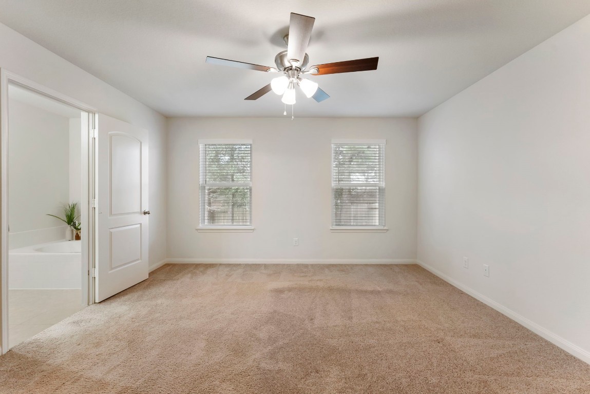 9159 Nina Road Conroe, TX 77304 - Photo 16 of 24 Primary bedroom with a view of the back yard.