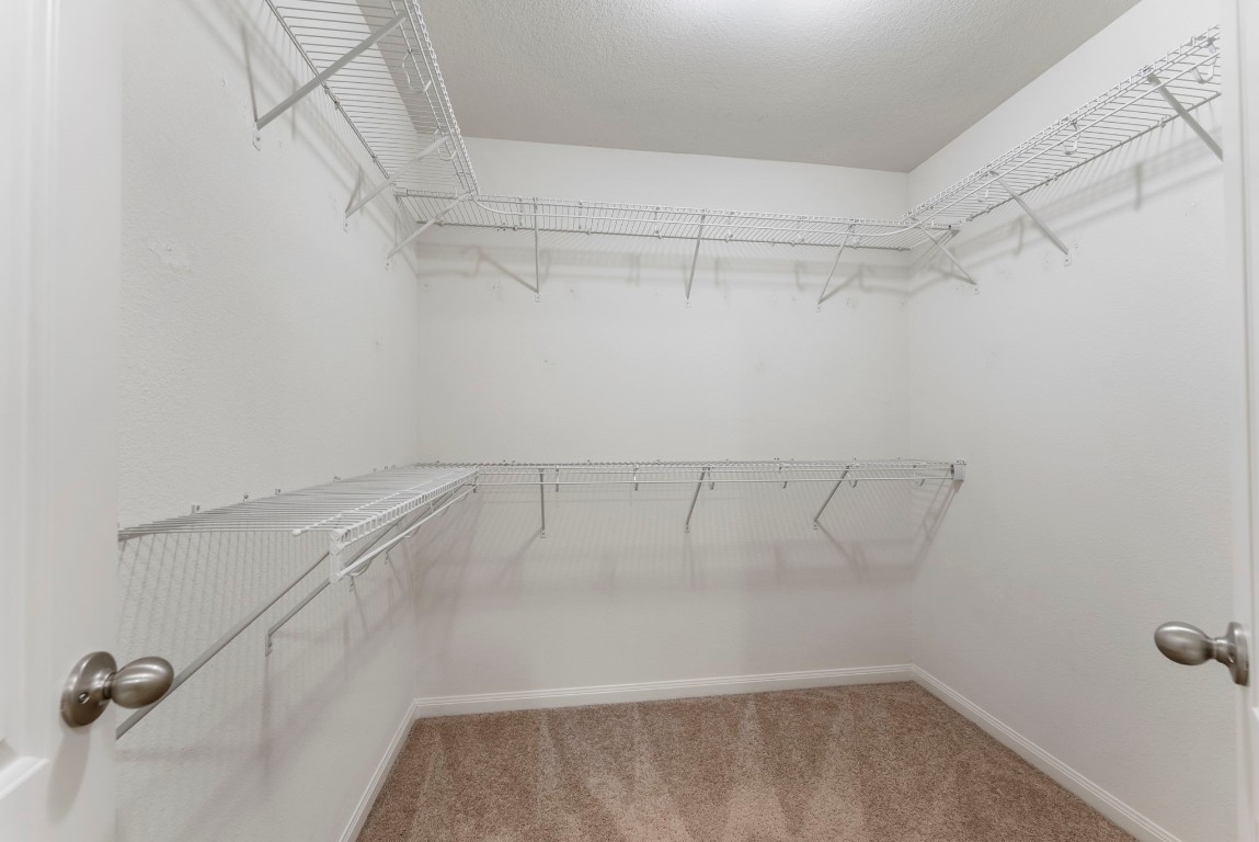 9159 Nina Road Conroe, TX 77304 - Photo 19 of 24 Primary walk-in closet with double racks for hanging.