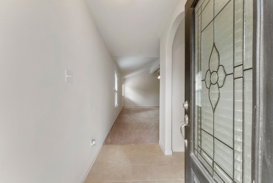 9159 Nina Road Conroe, TX 77304 - Photo 2 of 24 From the covered front patio, step into the home onto durable tile flooring, where fresh paint in the entry creates a bright, welcoming first impression.