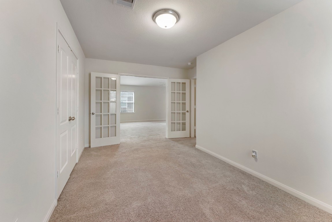 9159 Nina Road Conroe, TX 77304 - Photo 10 of 24 Another view of the home study or 4th bedroom with a double door closet space.