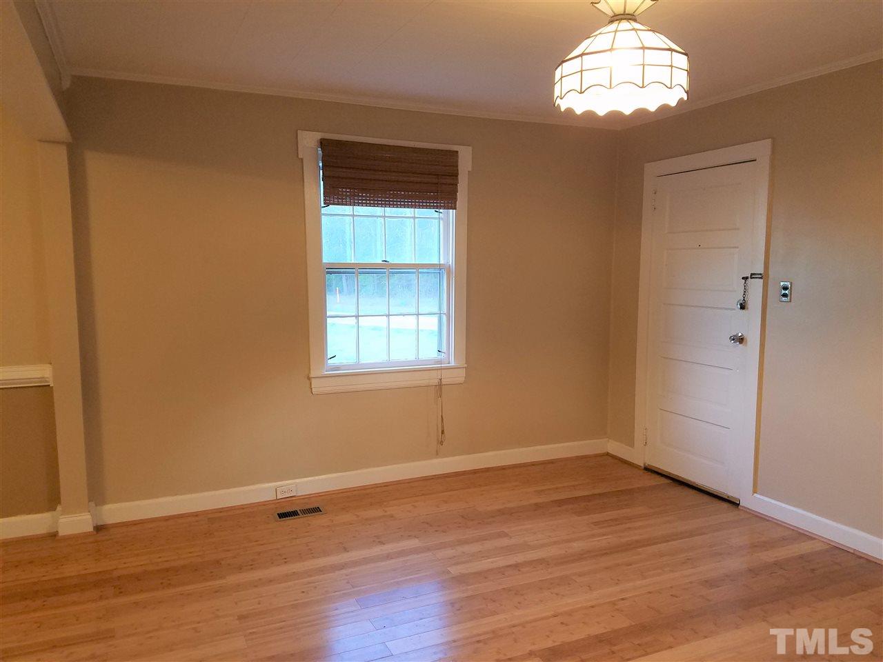 3105 East Garner Road Raleigh, NC 27610 - Photo 3 of 18 an empty room with wooden floor and windows