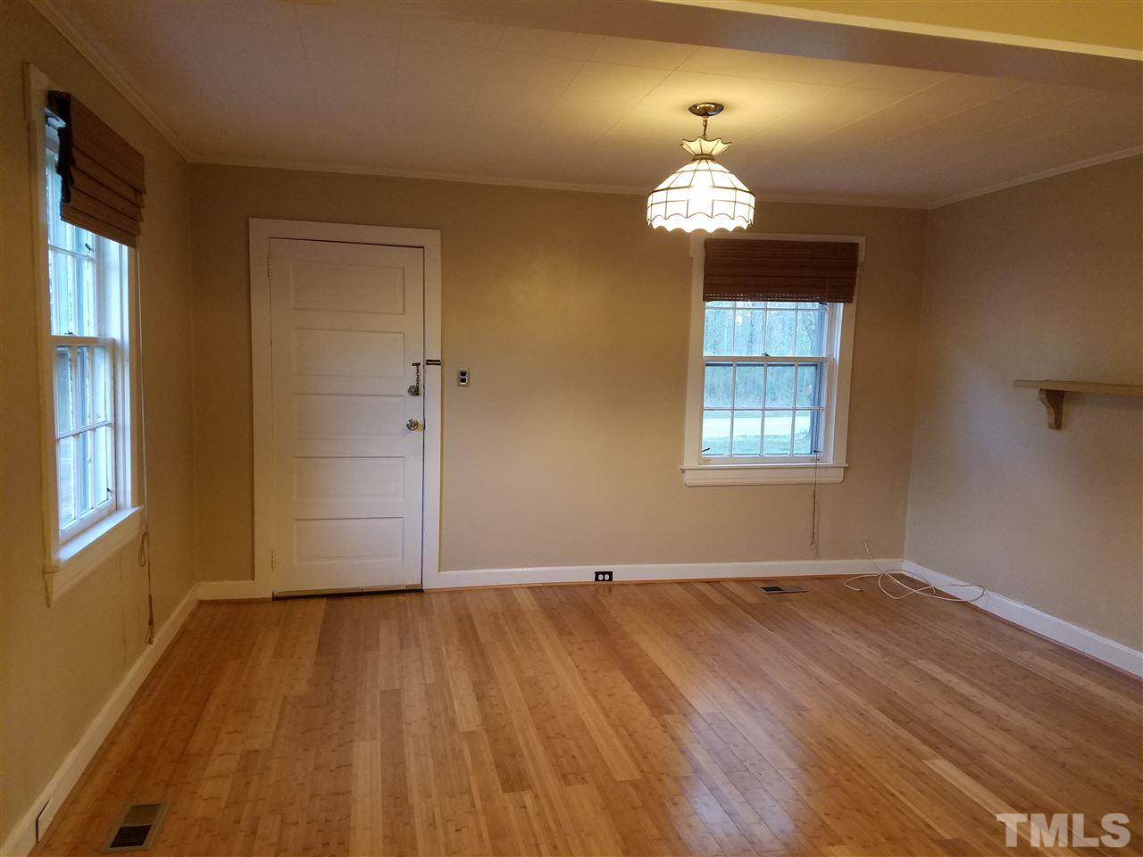 3105 East Garner Road Raleigh, NC 27610 - Photo 4 of 18 wooden floor in an empty room with a window