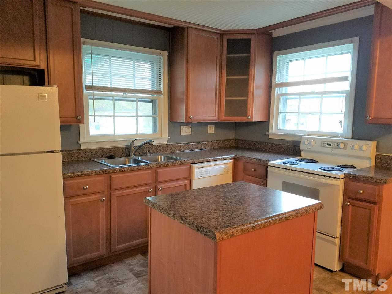 3105 East Garner Road Raleigh, NC 27610 - Photo 8 of 18 a kitchen with stainless steel appliances granite countertop sink stove and refrigerator