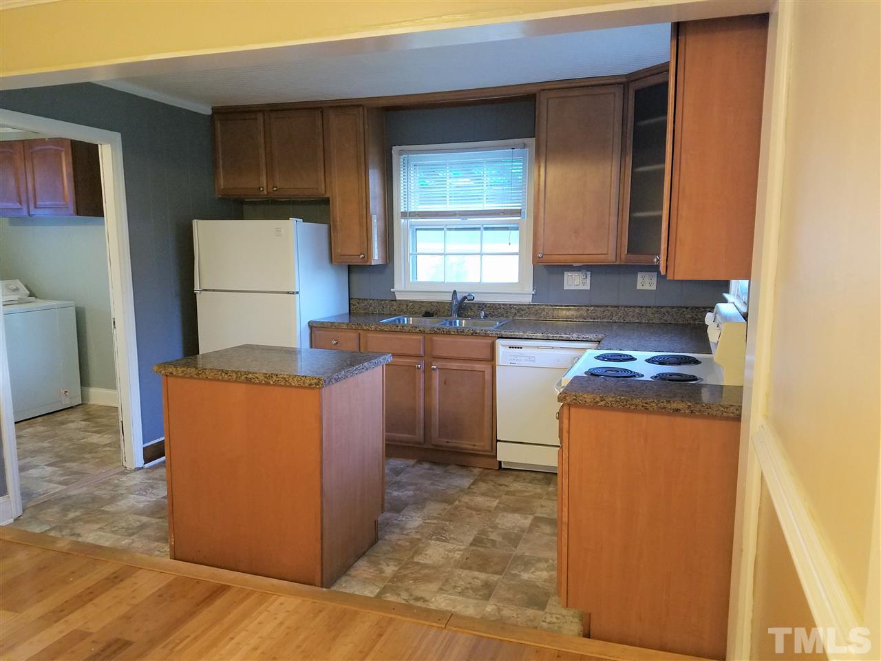 3105 East Garner Road Raleigh, NC 27610 - Photo 9 of 18 a kitchen with stainless steel appliances granite countertop a stove a sink a refrigerator and a microwave