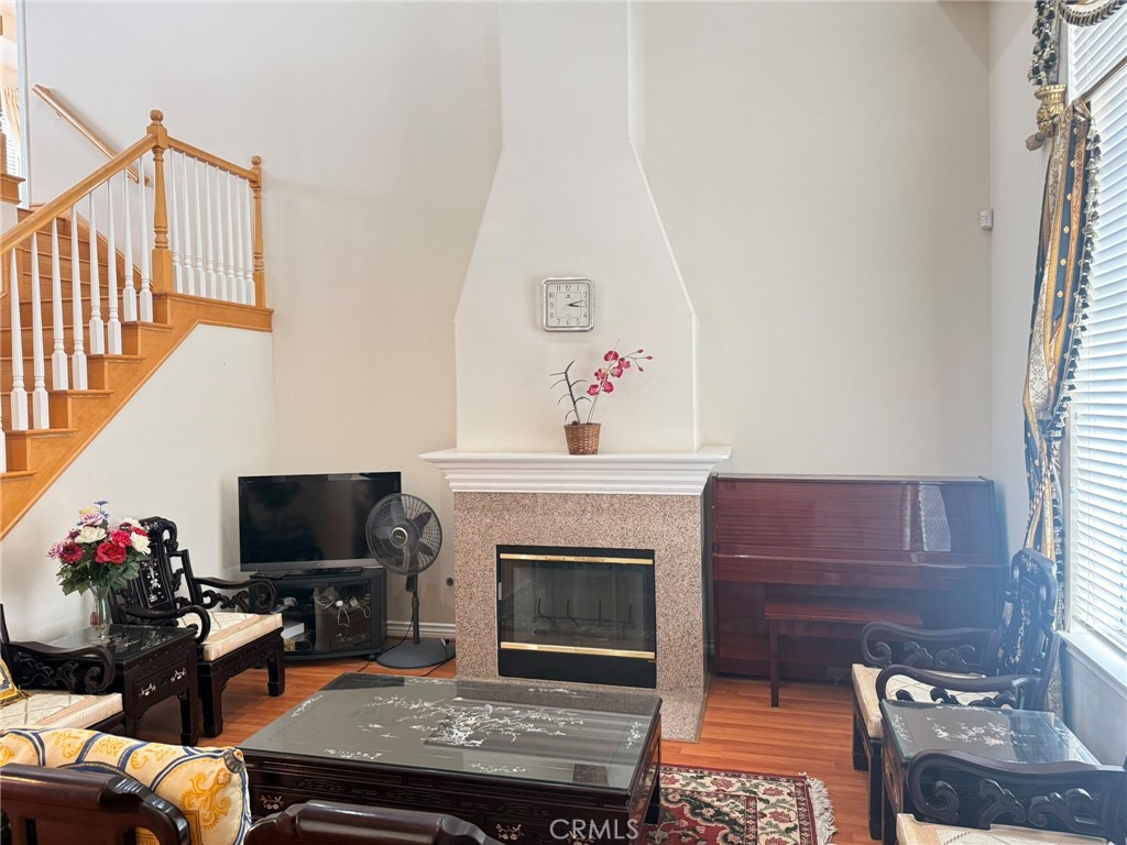 929 West Duarte Road, Unit B Arcadia, CA 91007 - Photo 4 of 11 a living room with furniture a flat screen tv and a fireplace