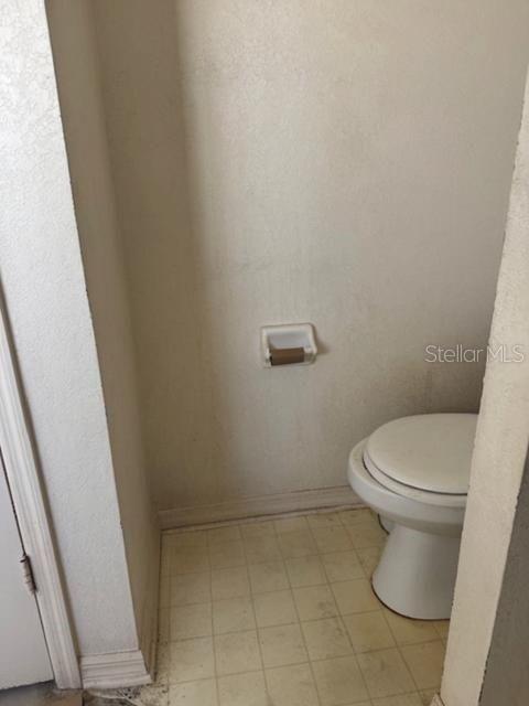 702 Tartan Loop Lake Wales, FL 33853 - Photo 14 of 20 a white toilet sitting next to a shower
