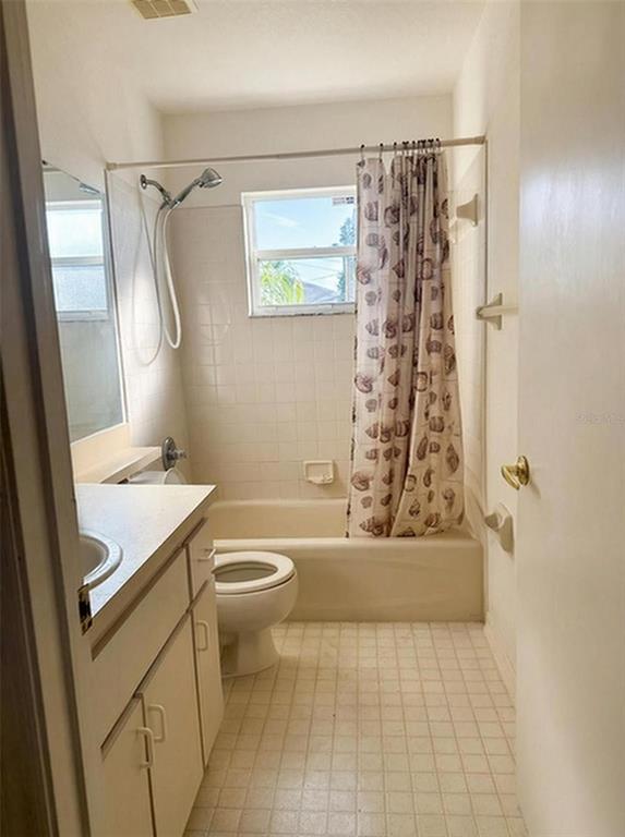 702 Tartan Loop Lake Wales, FL 33853 - Photo 16 of 20 a bathroom with a granite countertop sink toilet and shower
