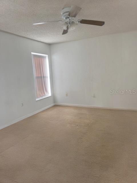 702 Tartan Loop Lake Wales, FL 33853 - Photo 8 of 20 an empty room with a window and a kitchen