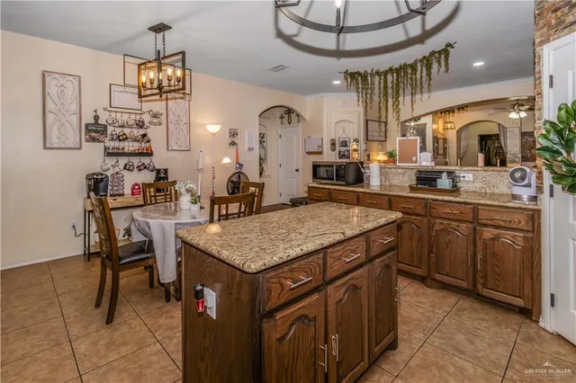 a kitchen with a sink a counter space appliances and cabinets