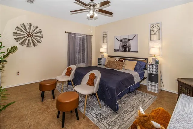 a bedroom with a bed and painting on the wall