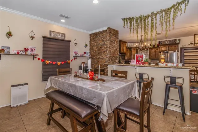 a kitchen with a table chairs and a refrigerator