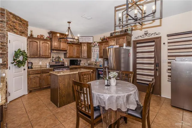 a kitchen with stainless steel appliances kitchen island granite countertop a sink and cabinets