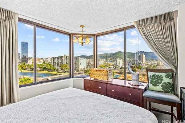 a room with a large window and a bed