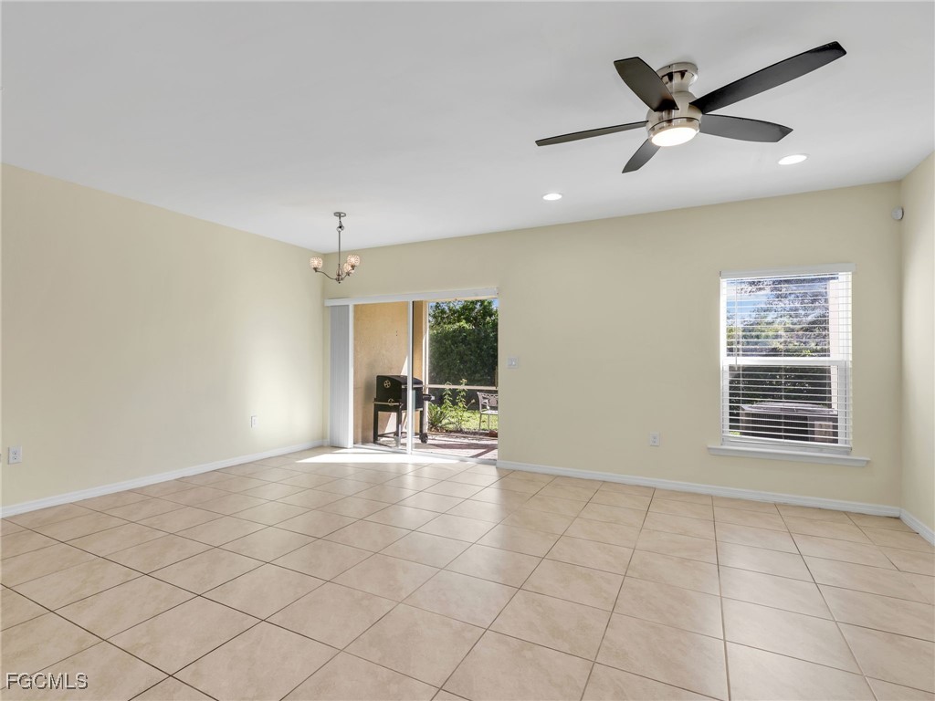 3886 Tilbor Circle Fort Myers, FL 33916 - Photo 11 of 30 a view of an empty room with a ceiling fan and window