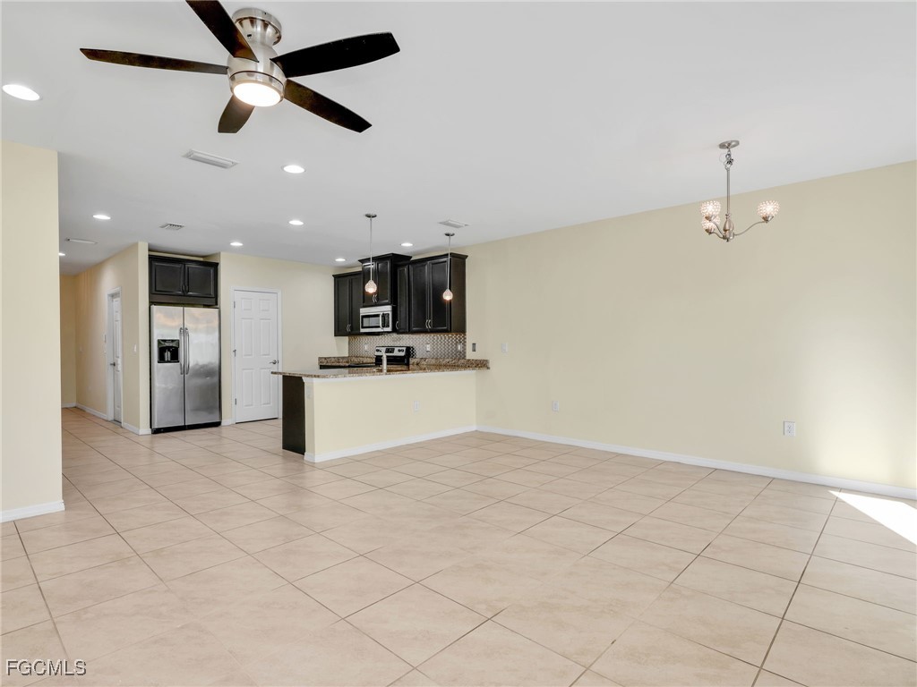 3886 Tilbor Circle Fort Myers, FL 33916 - Photo 12 of 30 a view of kitchen with microwave and refrigerator
