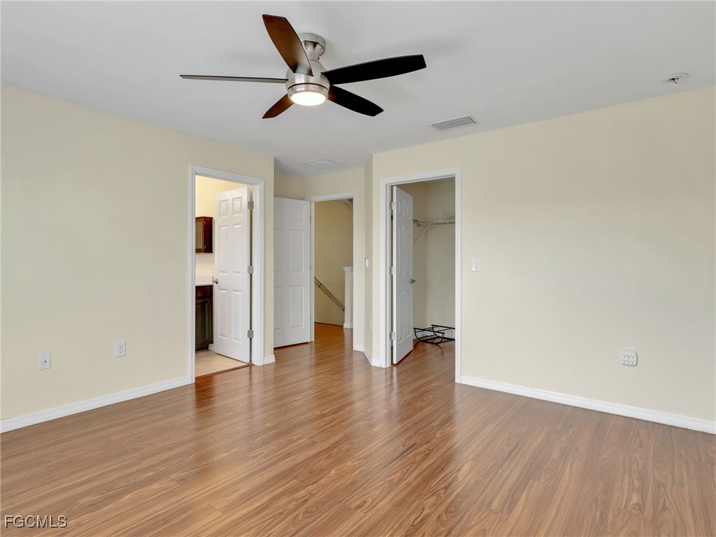 3886 Tilbor Circle Fort Myers, FL 33916 - Photo 20 of 30 an empty room with wooden floor and ceiling fan