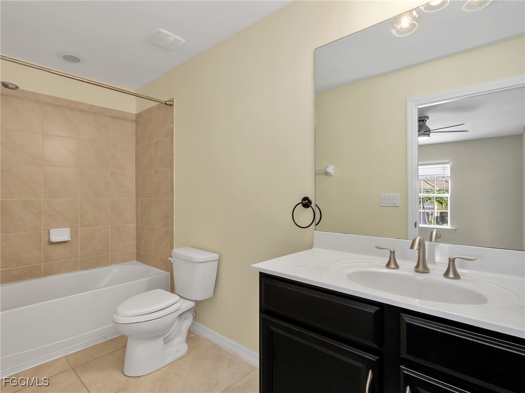 3886 Tilbor Circle Fort Myers, FL 33916 - Photo 25 of 30 a bathroom with a sink a toilet a mirror and shower