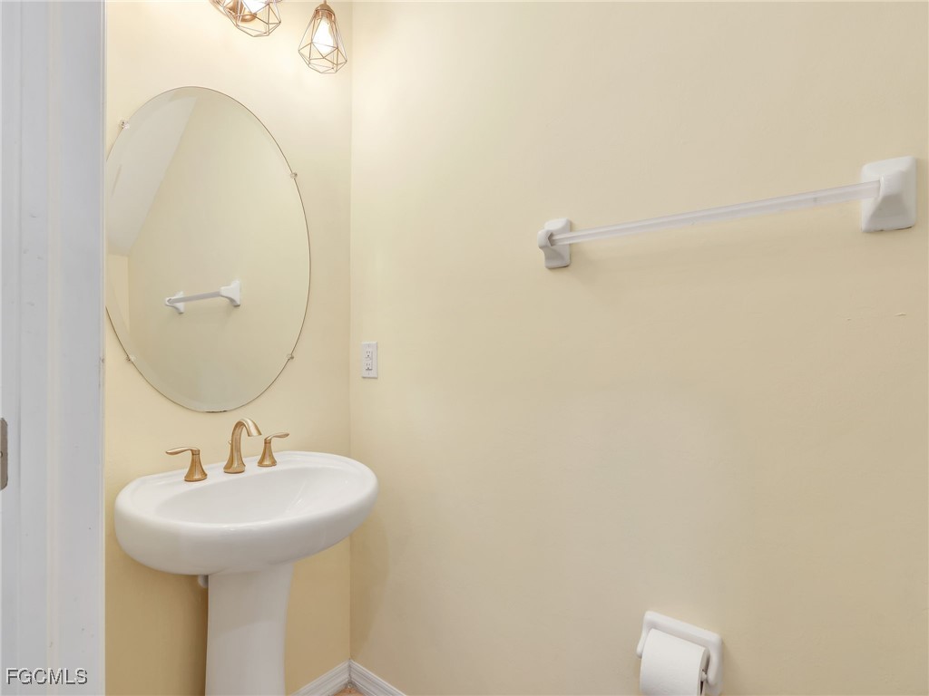 3886 Tilbor Circle Fort Myers, FL 33916 - Photo 27 of 30 a bathroom with a sink and mirror