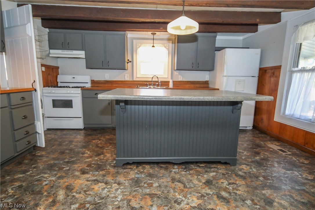 36671 Conner Ridge Road Woodsfield, OH 43793 - Photo 14 of 36 Kitchen with white appliances, a breakfast bar, gray cabinets, and a healthy amount of sunlight