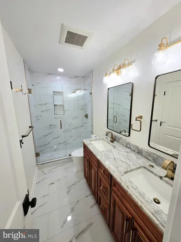 a bathroom with a sink a toilet and mirror