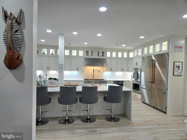 a kitchen with a dining table chairs and kitchen view