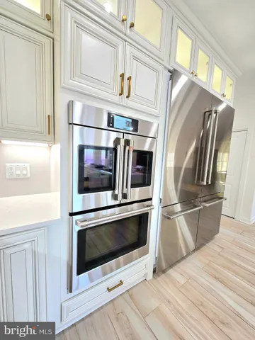 a kitchen with stainless steel appliances a refrigerator stove and microwave