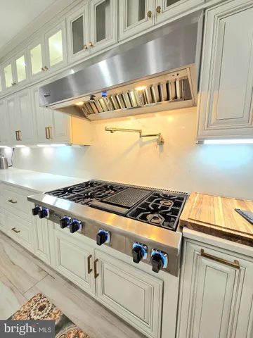 a kitchen with stainless steel appliances granite countertop a stove and a microwave