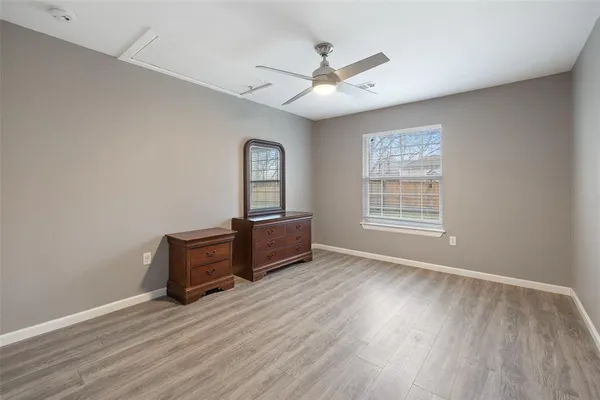 a view of workspace with wooden floor cabinet and windows