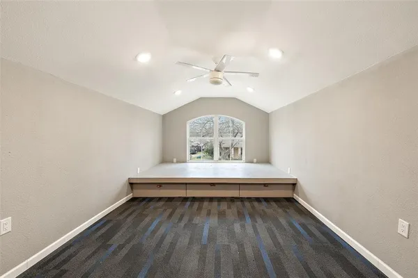 a view of a room with wooden floor and window