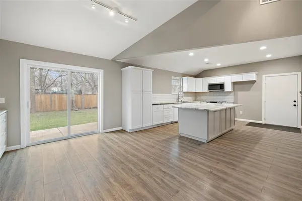 a view of kitchen with cabinets and wooden floor