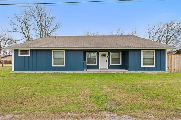 a house that has a big yard with large trees