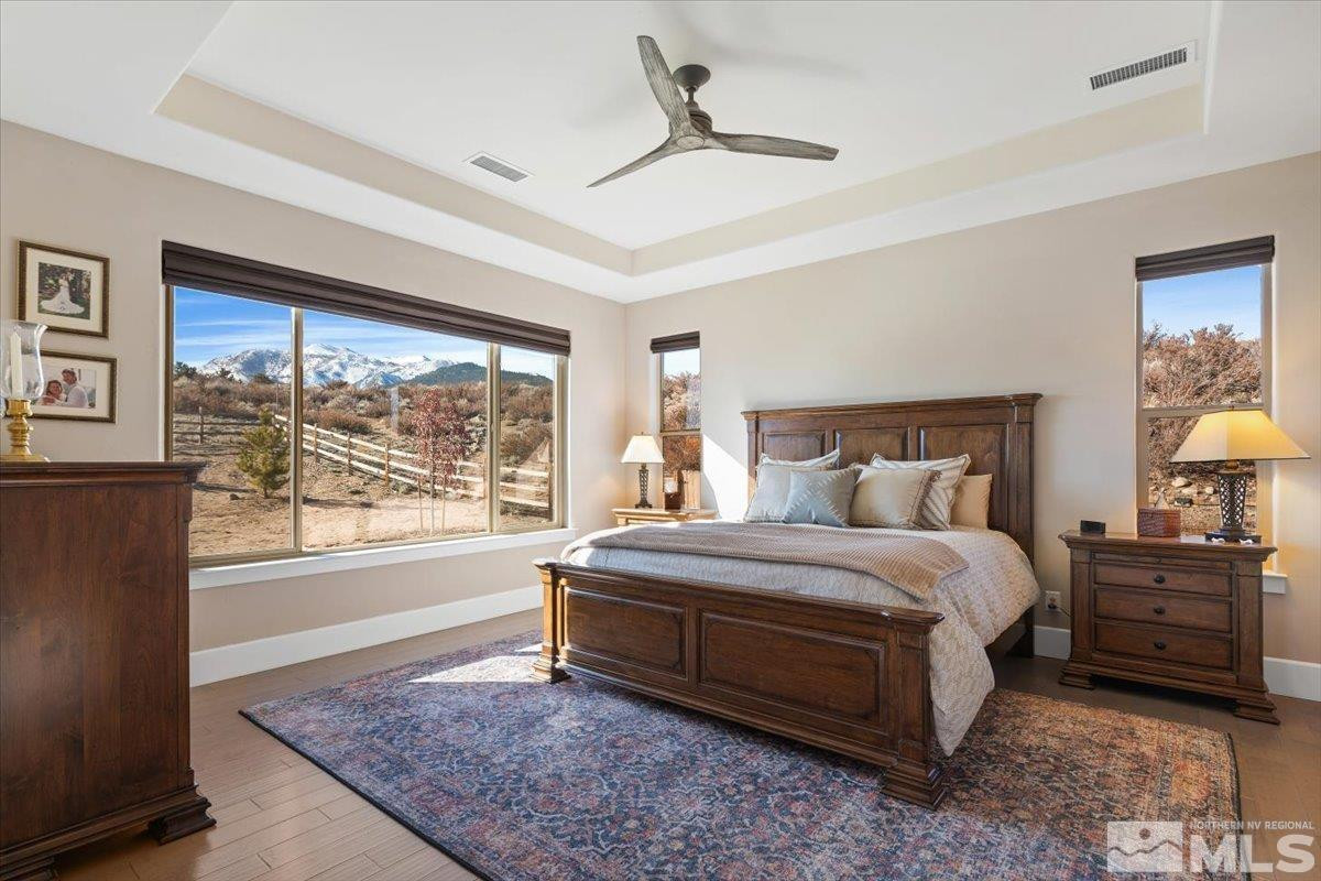 5720 Cevennes Court Reno, NV 89511 - Photo 16 of 40 a spacious bedroom with a bed a dresser and a large window
