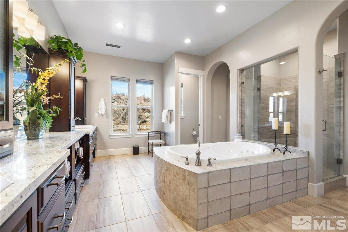 5720 Cevennes Court Reno, NV 89511 - Photo 19 of 40 a large spacious bathroom with a tub and shower