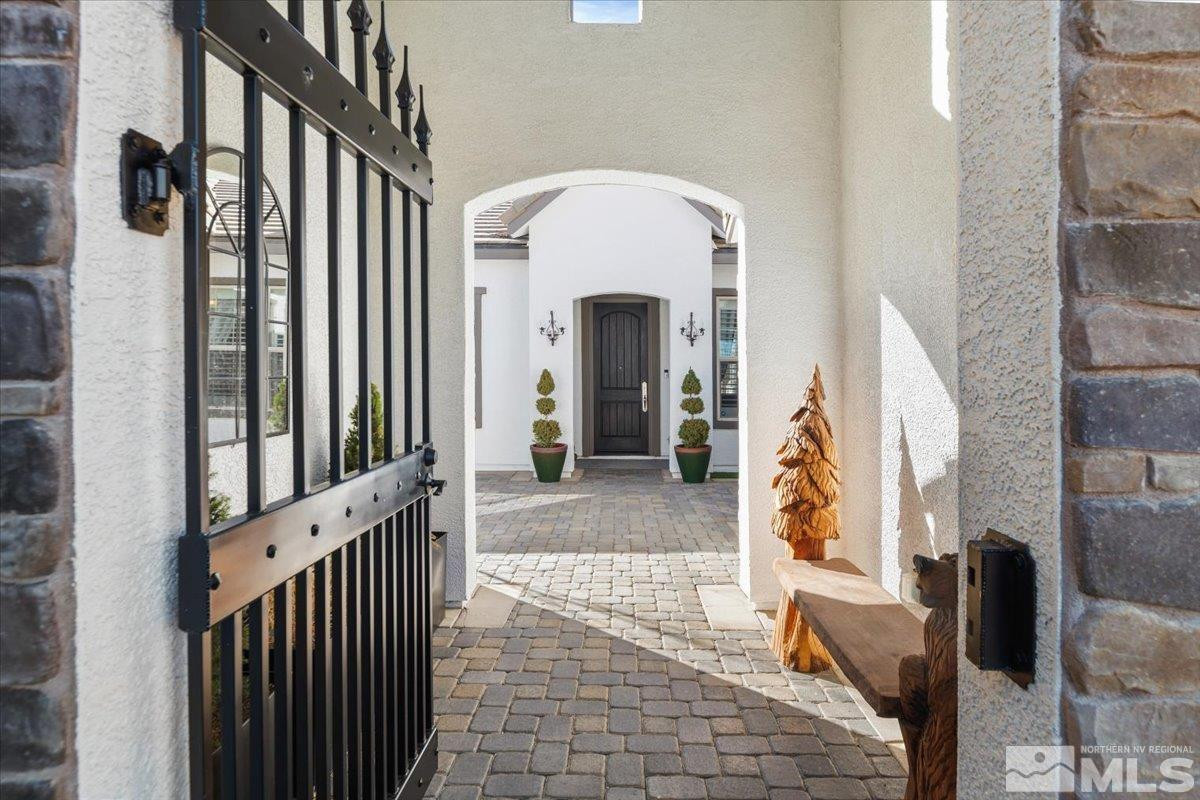 5720 Cevennes Court Reno, NV 89511 - Photo 4 of 40 a view of a hallway with entryway wooden floor and front door