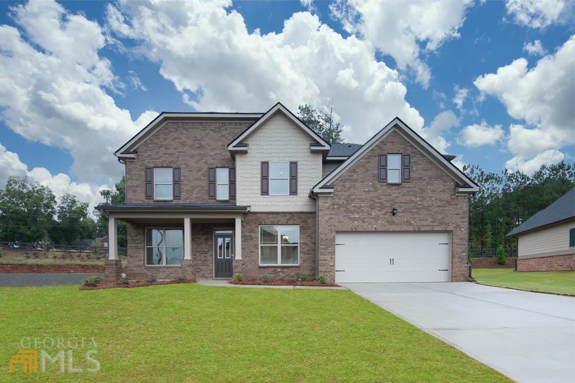 416 Beachview Road, Unit 57 Hampton, GA 30228 - Photo 1 of 1 a front view of a house with garden